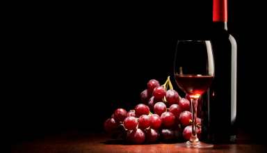 wine glass, wine bottle and grapes