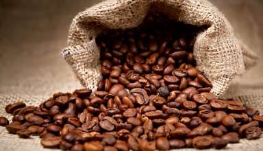 Coffee beans pouring out a bag