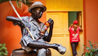 Havana, Cuba - statue of sitting man holding a Havana bottle