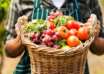 A man holding a basket of fresh vegetables