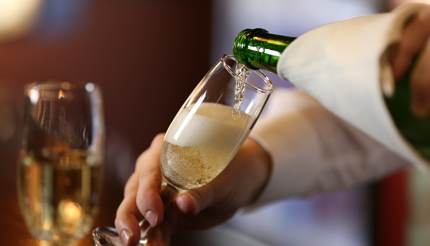Bartender pouring champagne into glass