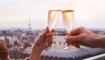 Two people clinking glasses of champagne or wine
